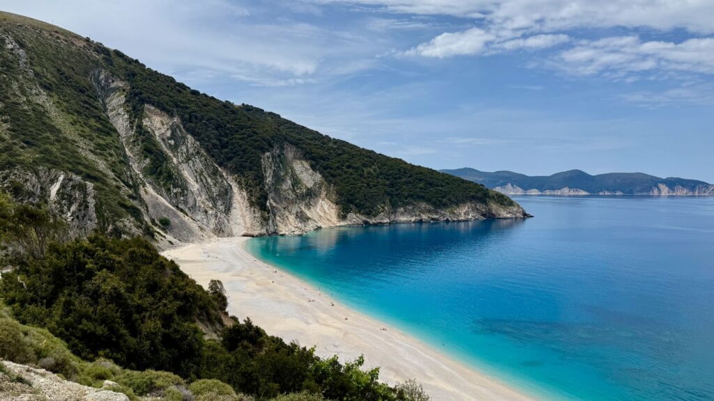 Myrtos beach on Kefalonia — white pebbles and turquoise water below green cliffs